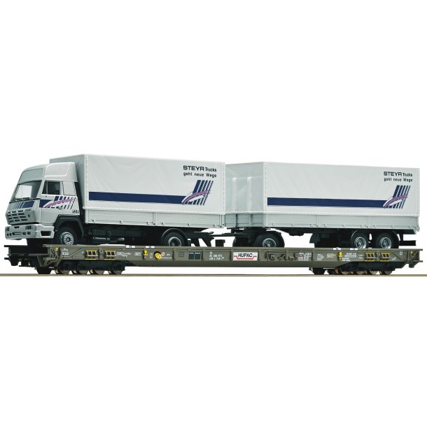 Roco HO 67530 HUPAC lavgulvsvogn mellem mellemliggende vogne "Rullende landevej" lastet med et Steyr-vogntog.